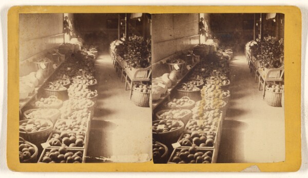 Unknown, [Baskets of fruits and vegetables at an interior marketplace]