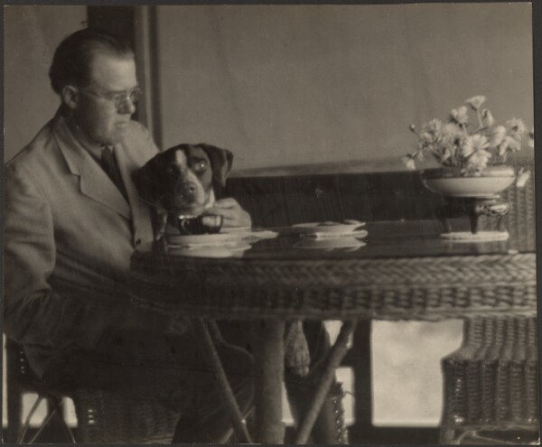 Louis Fleckenstein, [Man and Dog Seated at Table]