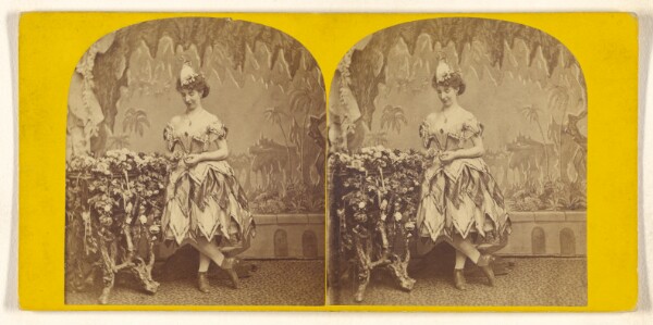 Unknown, [Woman posed by flower arrangement]