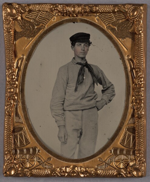 Unknown, [Portrait of a Young man wearing a cap and scarf, standing]