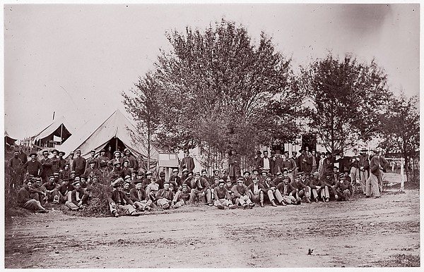 Unknown, [Unidentified Company of Soldiers at Ease, Seated on Ground in Tented Camp]