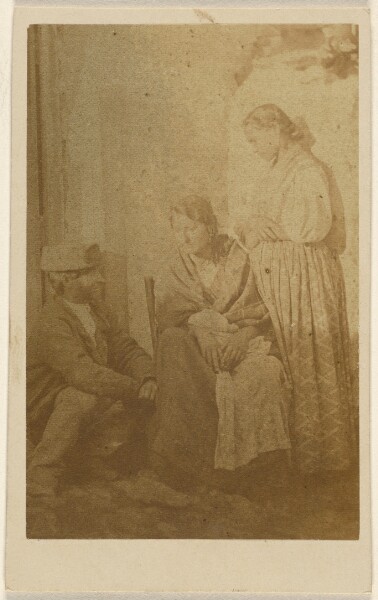 Unknown, [Woman seated holding a baby, a man and woman on either side]