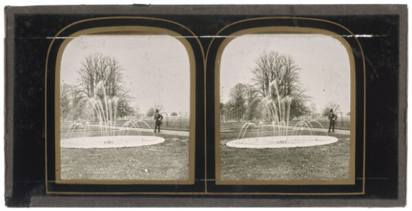 Unknown, [Unidentified man wearing a top hat standing near a lightly spouting fountain]