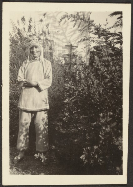 Louis Fleckenstein, [Woman in Costume Standing in Garden]