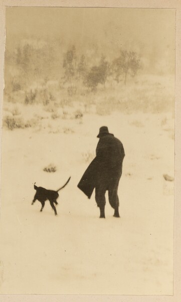 Unknown, [Man walking with dog running alongside]