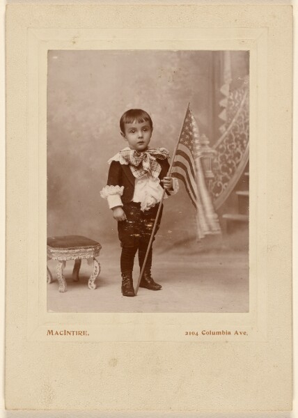 MacIntire, [Little boy standing, holding an American flag]