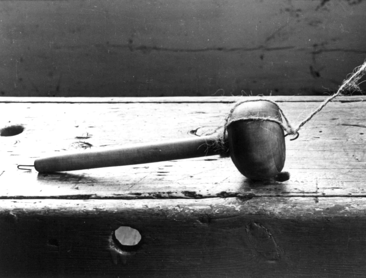 Anna Grostøl, Ragnhild Åvitsland spinner kutagl og grov ull på en liten hjemmelaget håndrokk i tre. Eiken, Hægebostad, Vest-Agder 1941.