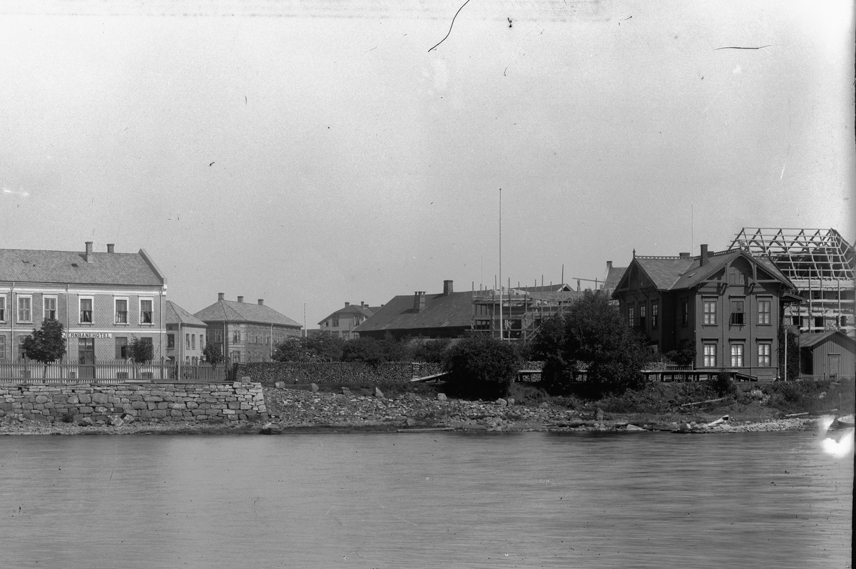 Hans Emil Erichsen, Jernbanehotellet i midten, den gamle Hamar Jernbanestasjon til høyre. Helt til høyre er Grand Hotell under oppføring.
