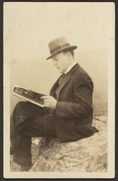 Louis Fleckenstein, [Man Reading Magazine on Rock]