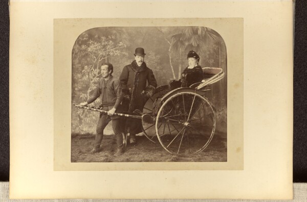 Unknown, [Studio portrait of a European couple posing with an Asian rickshaw puller]