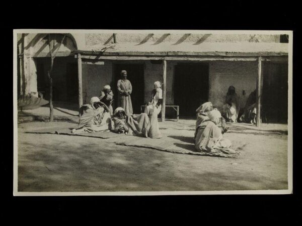 Unknown, Men sitting in the street a t the Cafe Maure, Bou Sada, Algeria.