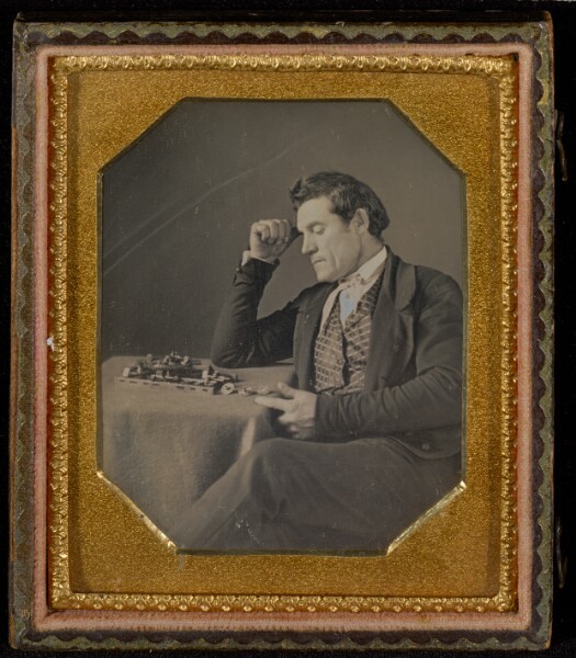 Unknown, [Man with a primitive calculating machine]