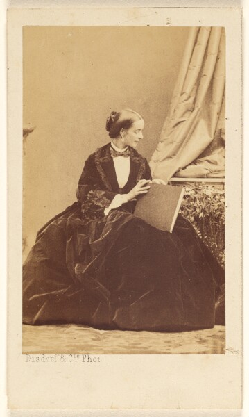 Disdéri & Cie., [Unidentified woman seated with a folio in her lap]