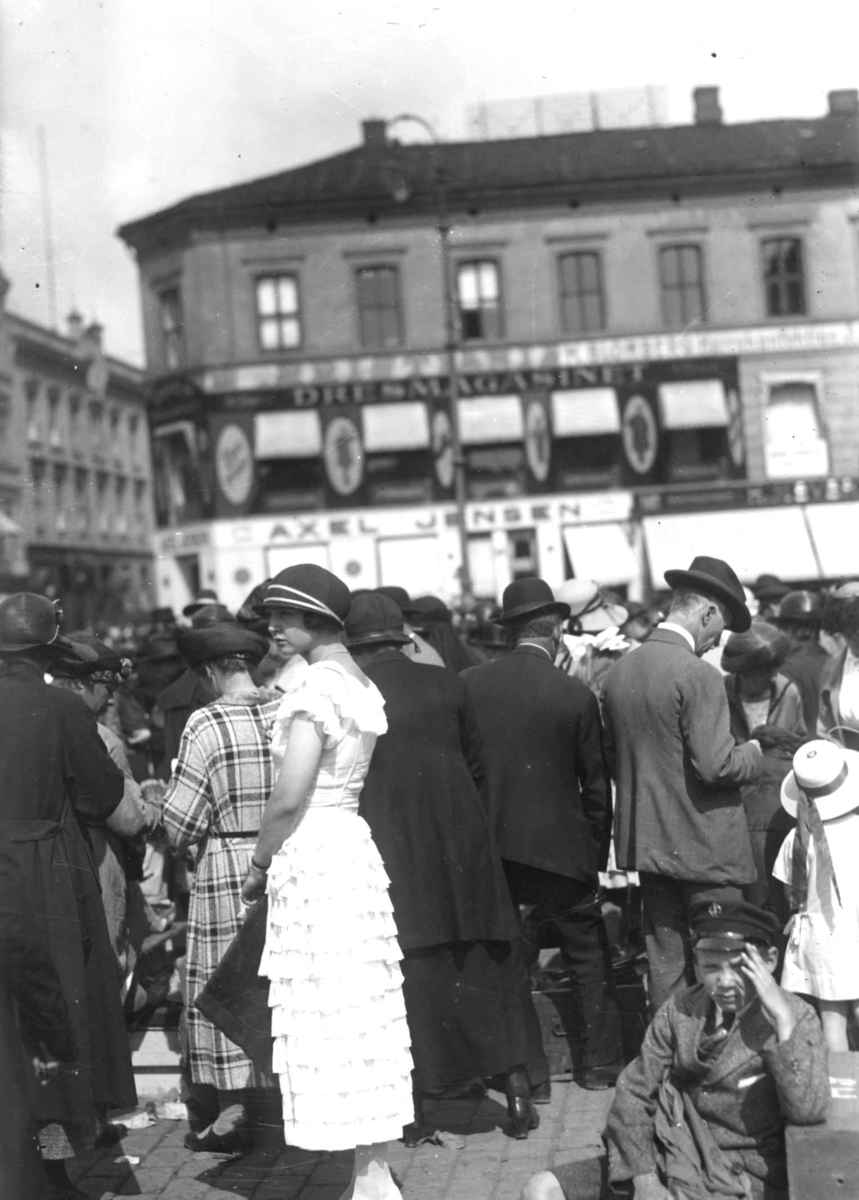 Hermann Christian Neupert, Sommerklær. Youngstorget, Oslo. 1924. Kvinner og menn på Youngstorget. Bybebyggelse i bakgrunnen.