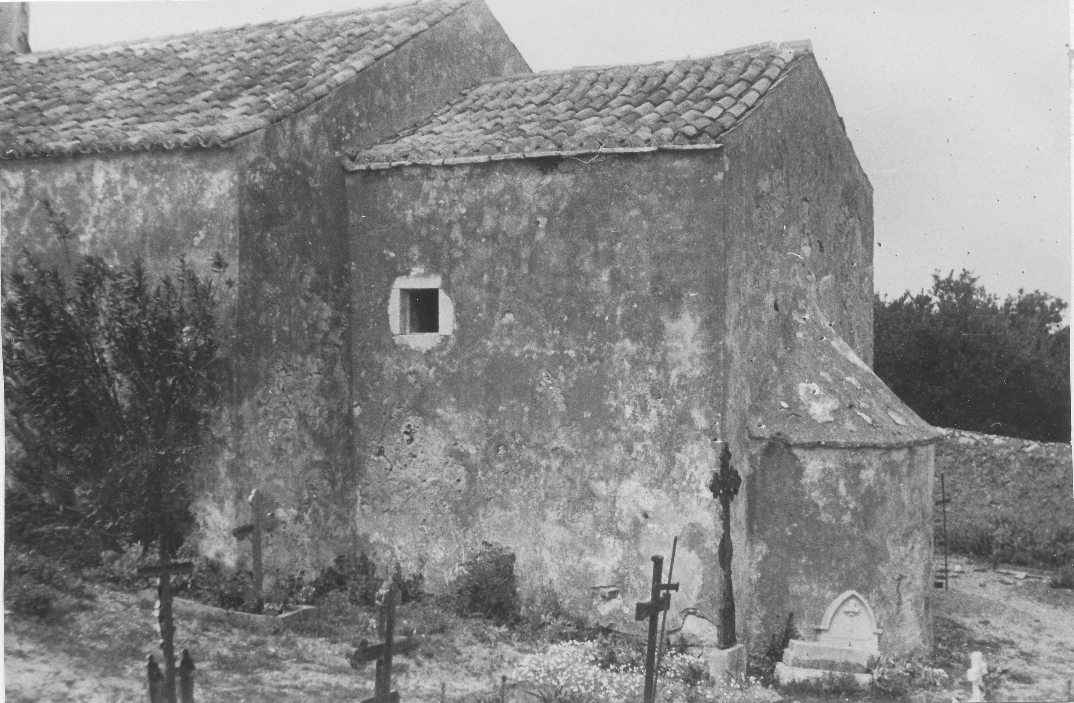Branko Fučić, Sveti Jakov (Mali Lošinj), crkva sv. Jakova na groblju, dio vanjštine: pogled na dio građevine s jugoistočne strane; stupnjevanje gradbenih volumena zaključuje mala rustična apsida začelnog zida