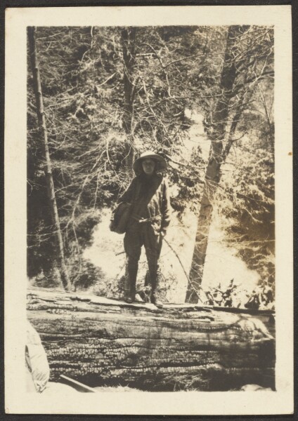 Louis Fleckenstein, [Woman Standing on Fallen Tree]