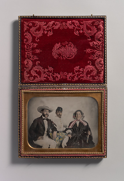 Unknown, [Two Men, One in Military Garb, and a Woman, Seated Around a Table]