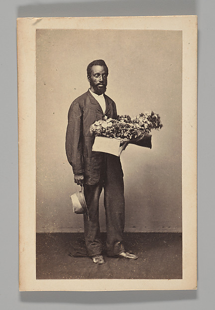 Unknown, [Studio Portrait: Male Street Vendor Holding Box of Flowers, Brazil]