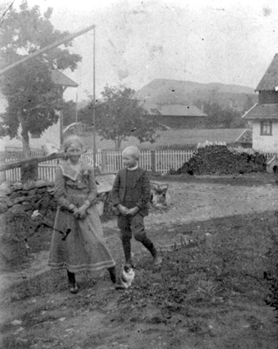 Anno Domkirkeodden, 2 barn på tunet på Buttekvern gård, Brumunddal. Signe og Einar Lundby.