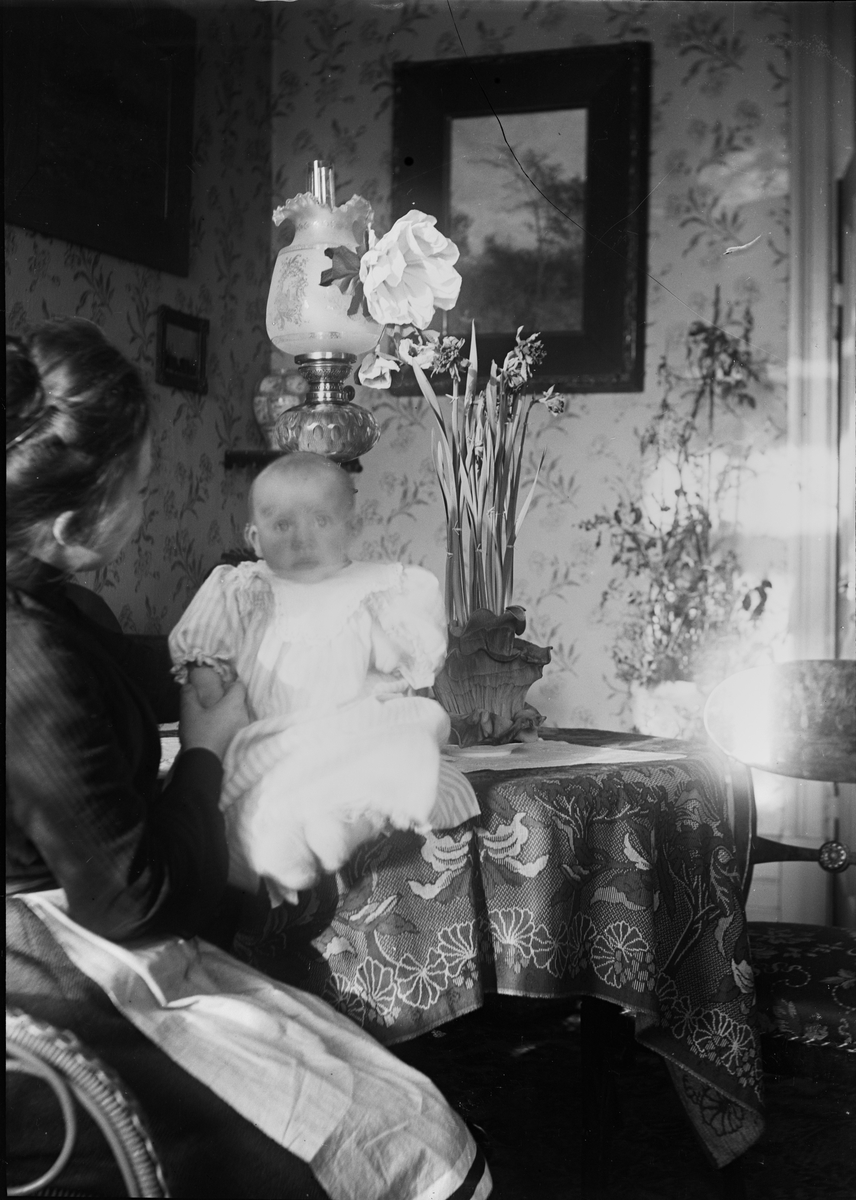 Okänd,, Christiane Liljefors with one of his children, possibly his son Roland, likely at home in Sweden 1900s