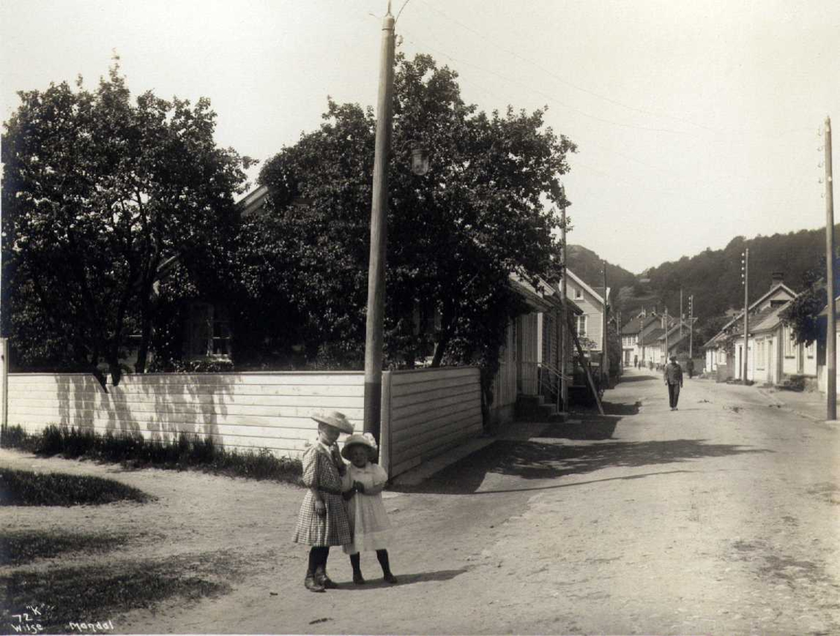 Anders Beer Wilse, Gateparti, Mandal, Vest-Agder. Fotografert 1912. To jenter i forgrunnen.
