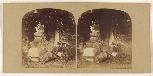 Unknown, [Boy on ground reading a letter or book]