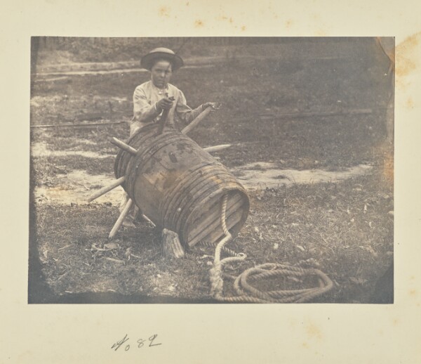 A. J. Russell, [Child leaning against a barrel anchor]