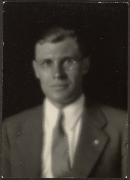 Louis Fleckenstein, [Portrait of a Man with Glasses and Lapel Pin]