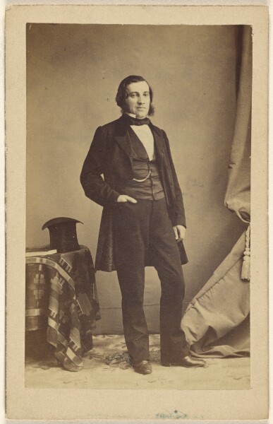 Unknown, [Unidentified man standing with his hand in his pocket, a top hat on a table nearby]