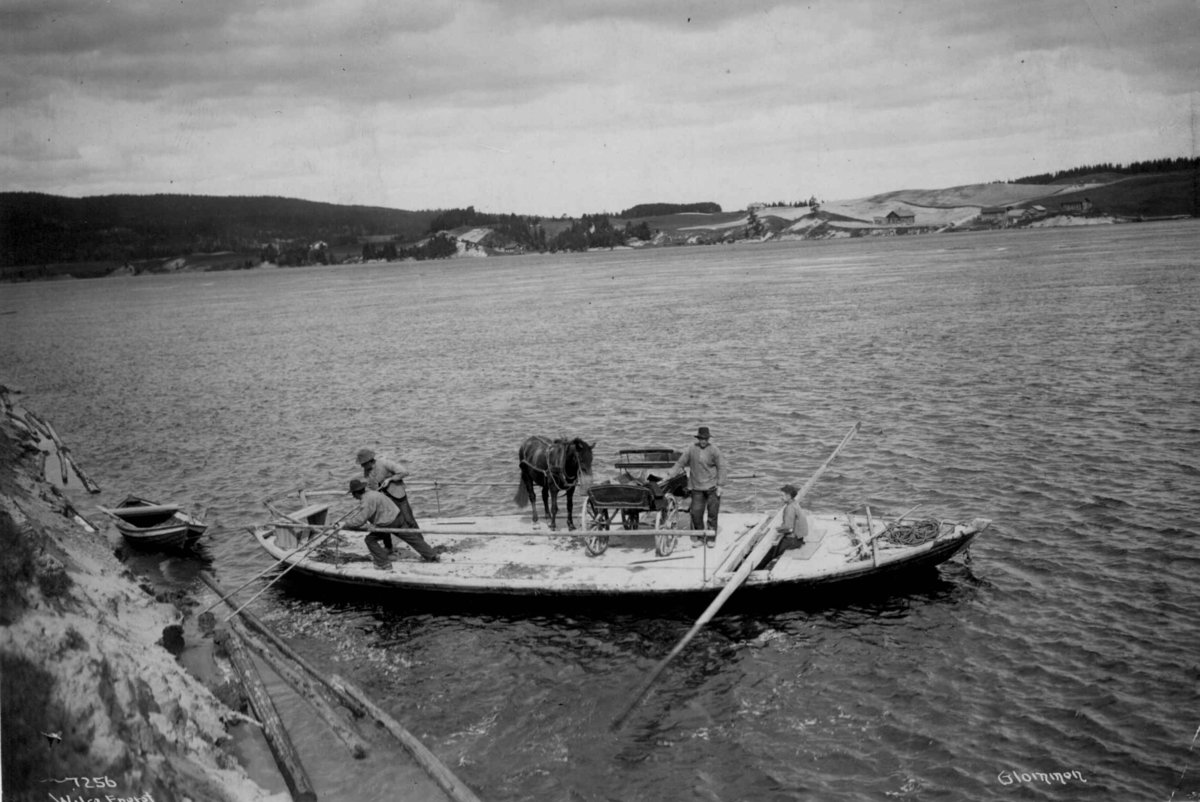Anders Beer Wilse, Ferge for hestekjøretøy, ant. Glomma, Hedmark. 1907. På fergen står en trille.