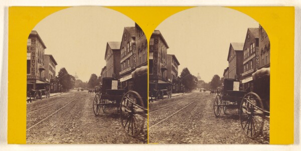 Unknown, [Unidentified American main street, streetcar tracks down center]