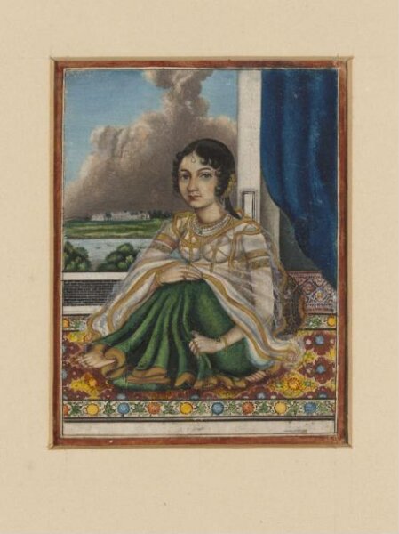 Unknown, An Indian lady seated on a carpet by an open door overlooking a river with a European-style house on the opposite bank.